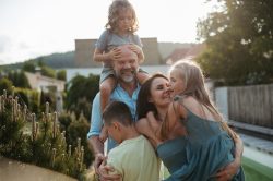 Family hugging in backyard.